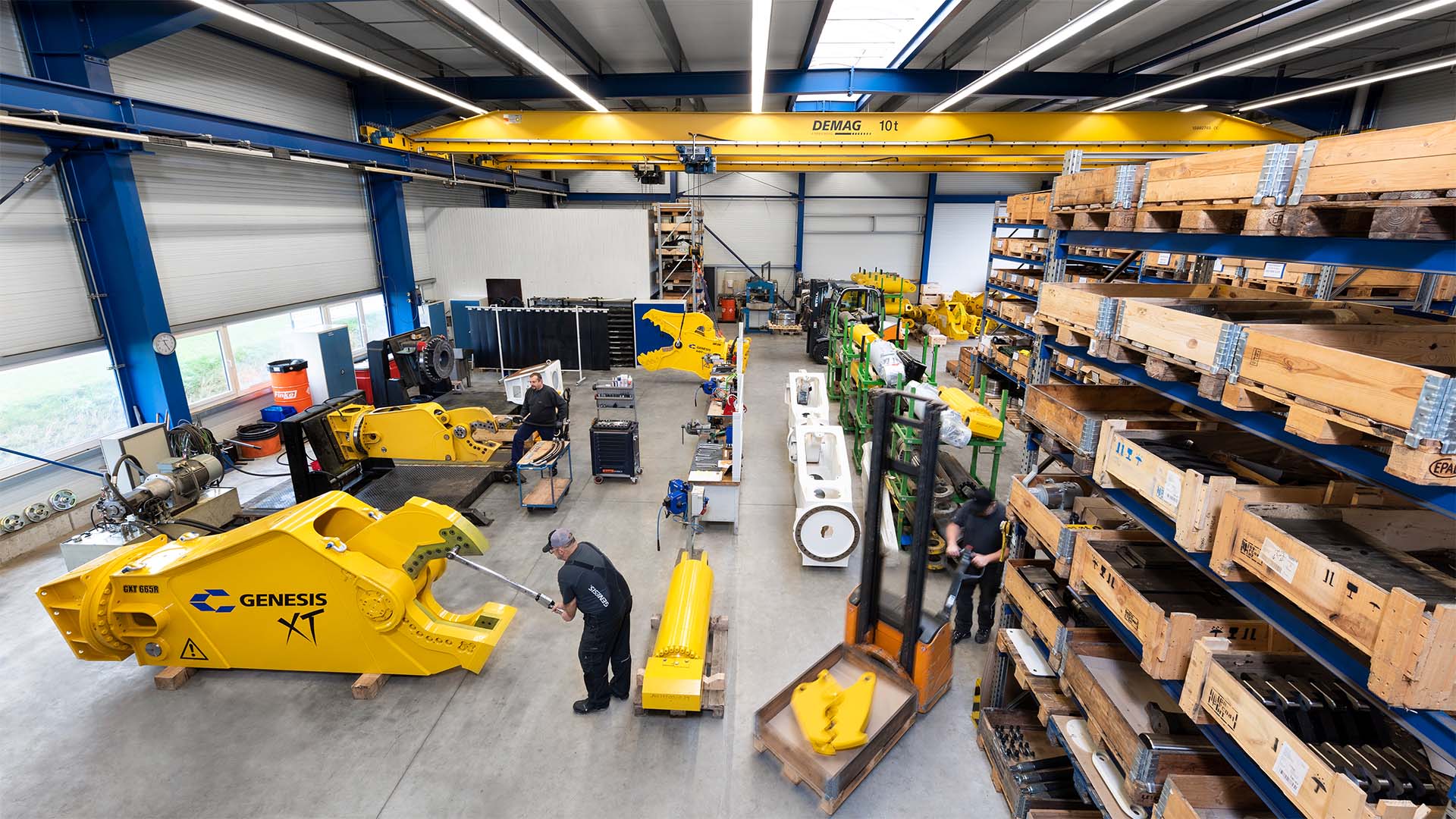 Service technicians performing maintenance and repair work on Genesis hydraulic shears in the workshop